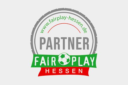 Logo von Fair Play Hessen mit dem Wort "PARTNER" und einem Fußball in der Mitte, umrahmt von einem grauen Kreis.