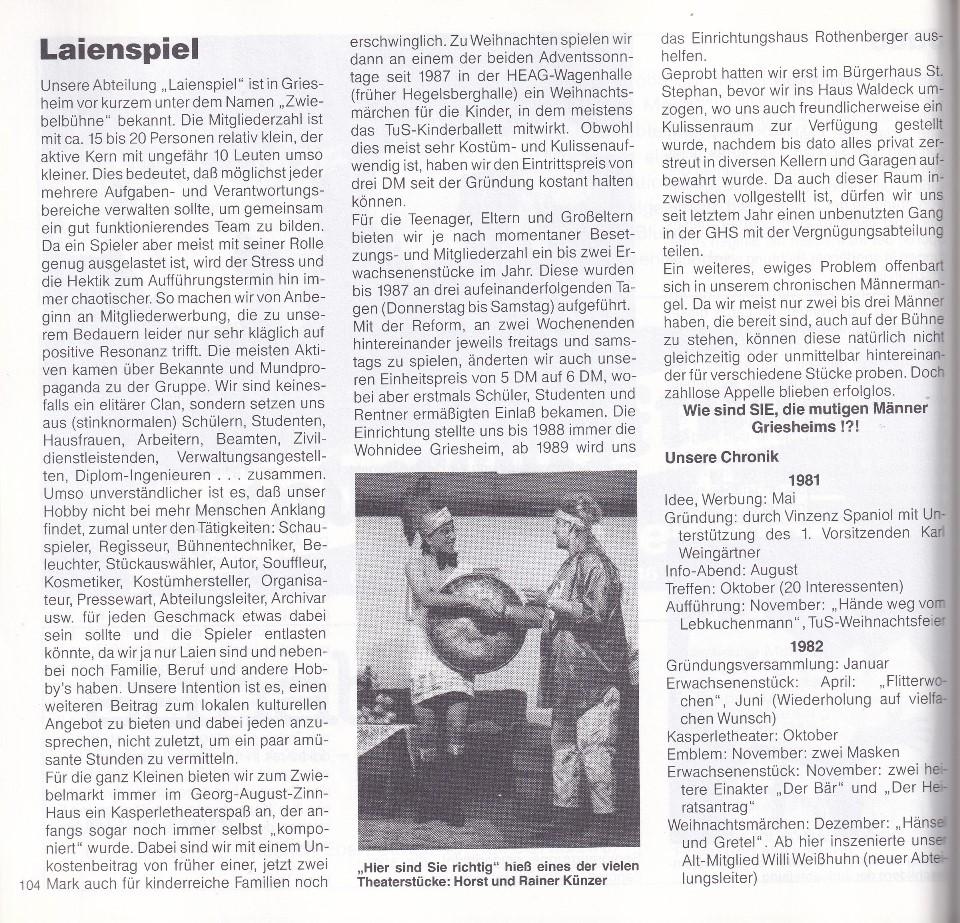 Schwarz-weiß-Foto von zwei Männern bei einer Theateraufführung, einer mit einer großen Trommel, der andere im Gespräch.