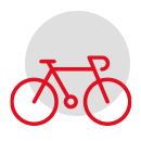 Rotes Fahrradsymbol auf schwarzem Hintergrund, teilweise von grünem Gras umrahmt.