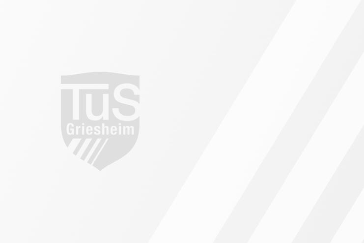Logo von TuS Griesheim auf einem hellen Hintergrund, stilisiert mit diagonalen Streifen in hellerem Weiß.